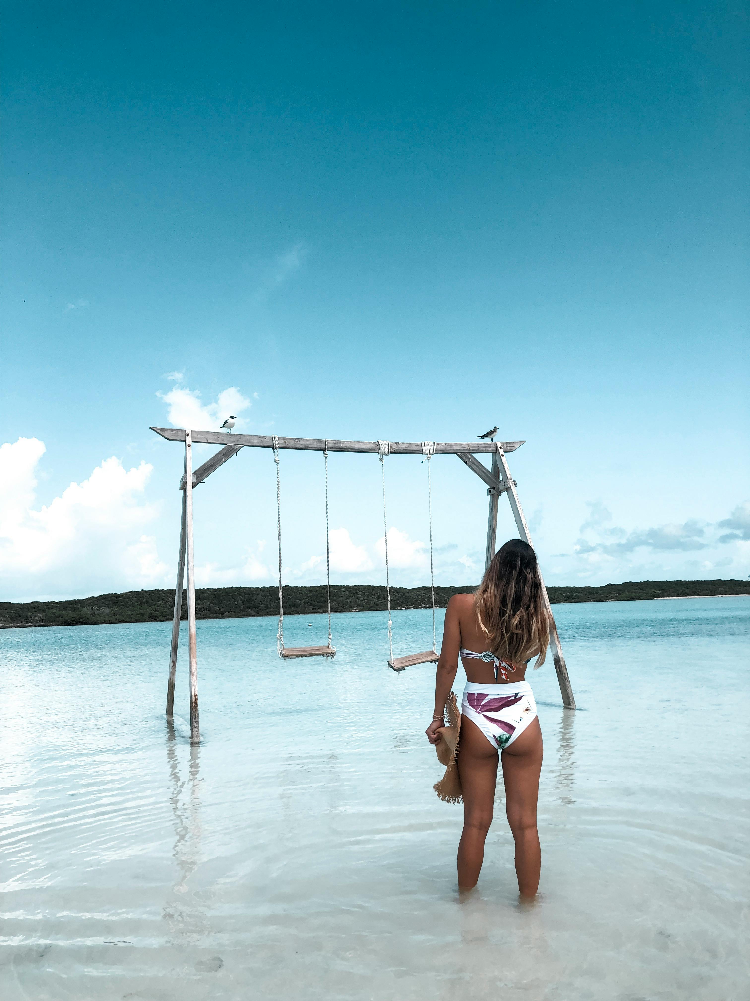 Bahamas sandbar with wooden swing over turquoise water